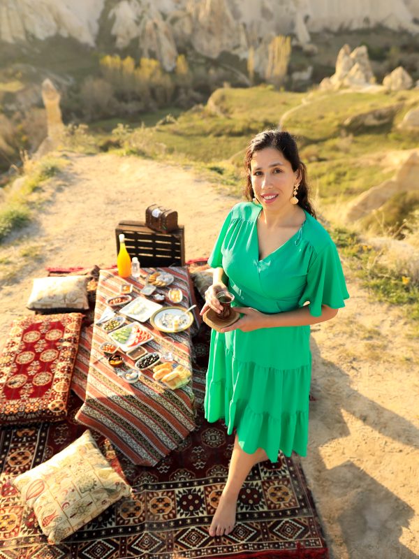 Exclusive Cappadocia sunrise breakfast setup with traditional Turkish cuisine and balloon backdrop.