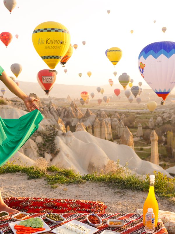 Luxury sunrise breakfast experience in Cappadocia with hot air balloons and panoramic valley views.